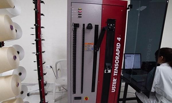  Uster Tensorapid 4 Tensile Testing Machine with Operator in Textile Lab